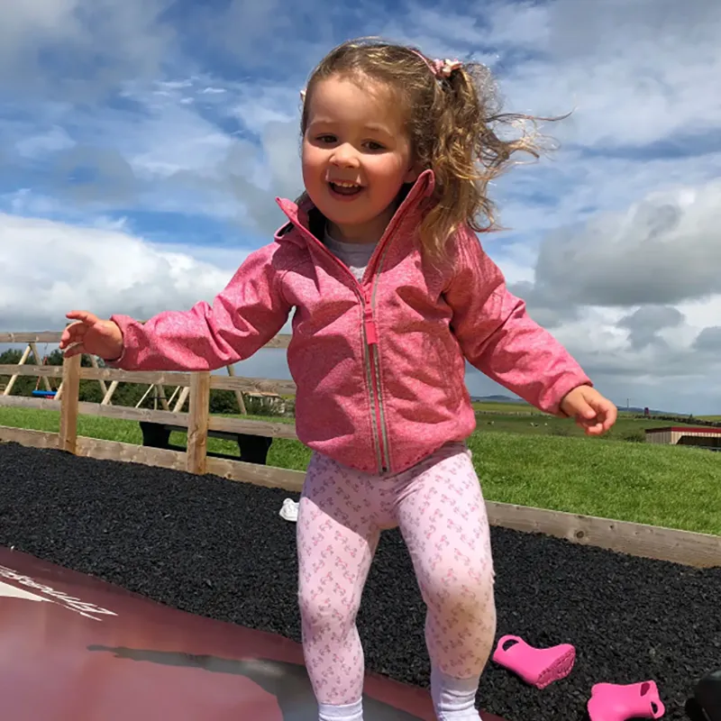 Girl enjoying outdoor play at Ernespie Farm