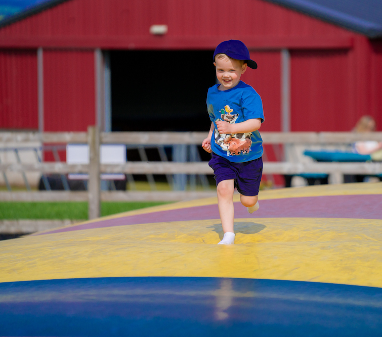 boy enjoying outdoor play at Ernespie Farm